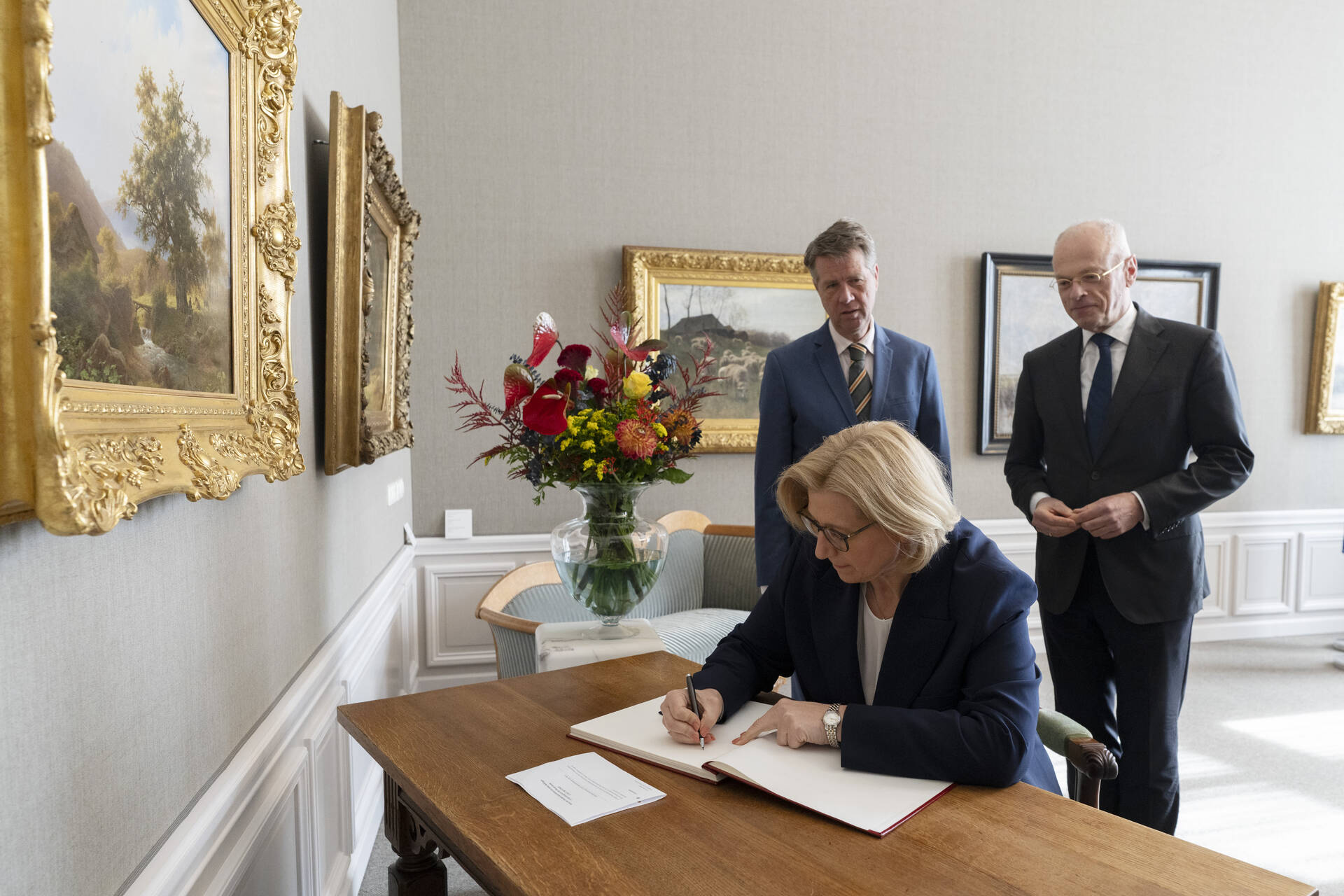 De voorzitter van de Bundesrat ondertekent het gastenboek.
